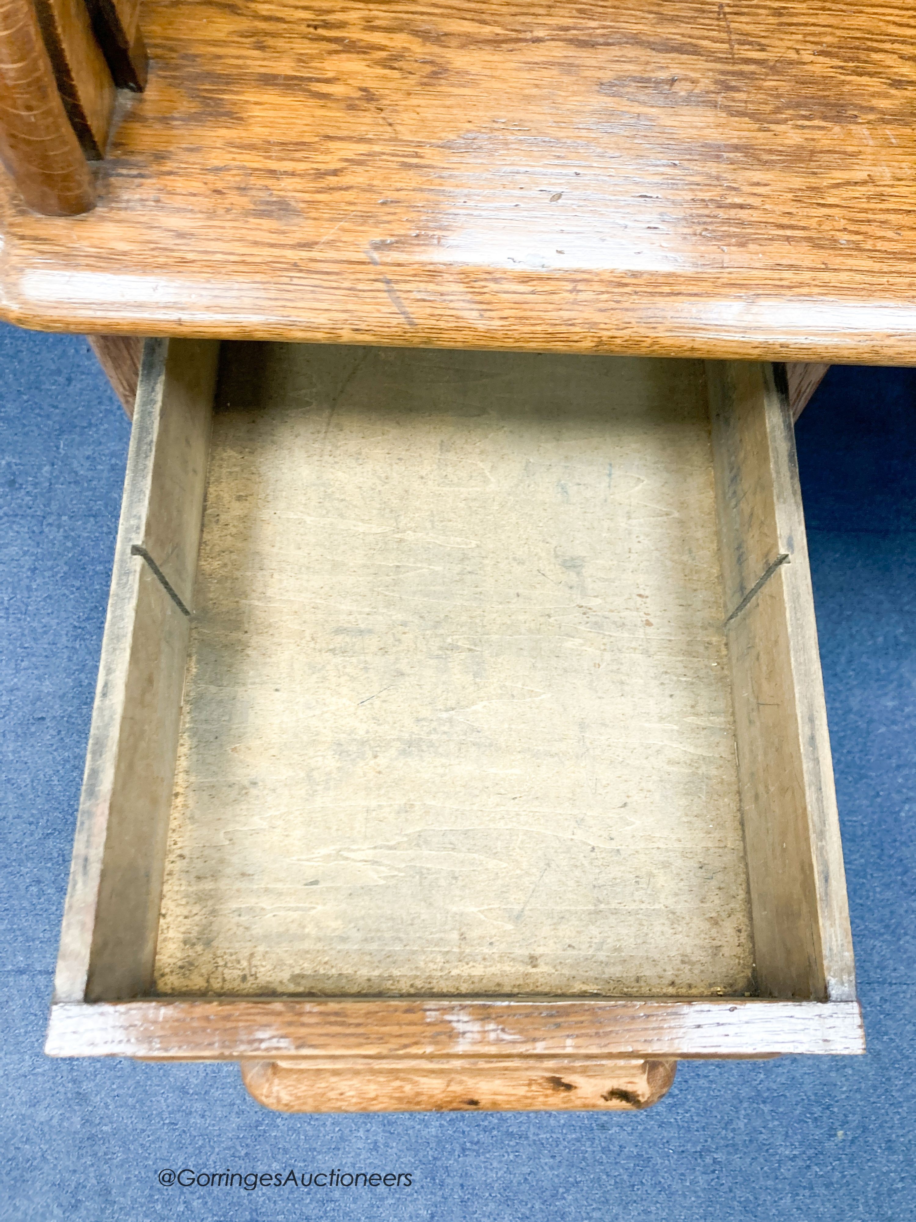 An early 20th century oak roll top desk with 'S' shaped tambour, width 120cm, depth 78cm, height of 124cm